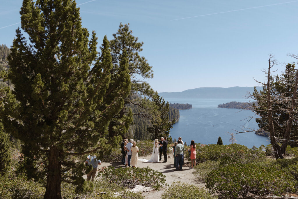 Elopement ceremony at Emerald Bay next to pine trees with Lake Tahoe in background