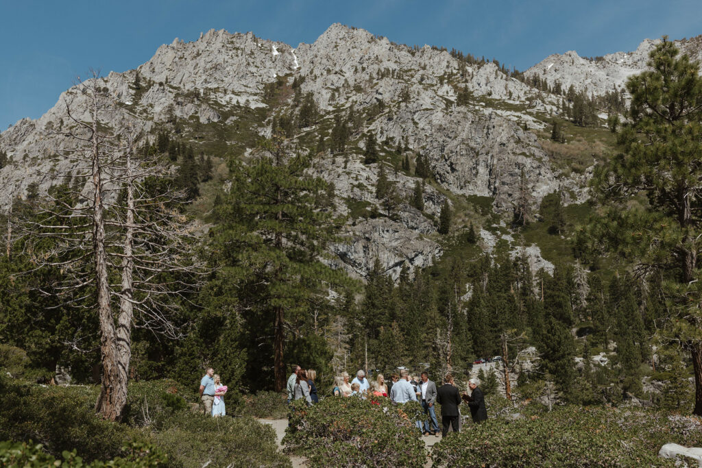 Elopement ceremony at Emerald Bay with large rocky mountains in background
