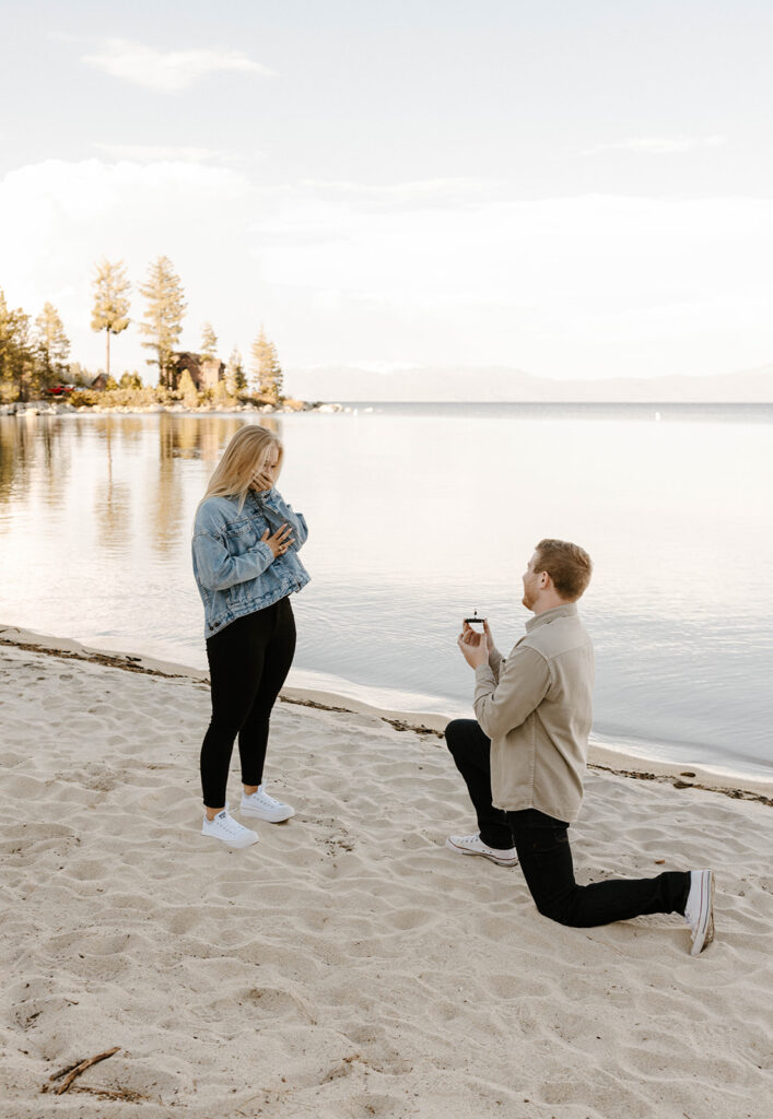 man on one knee proposing on the beach proposing to woman in the summer