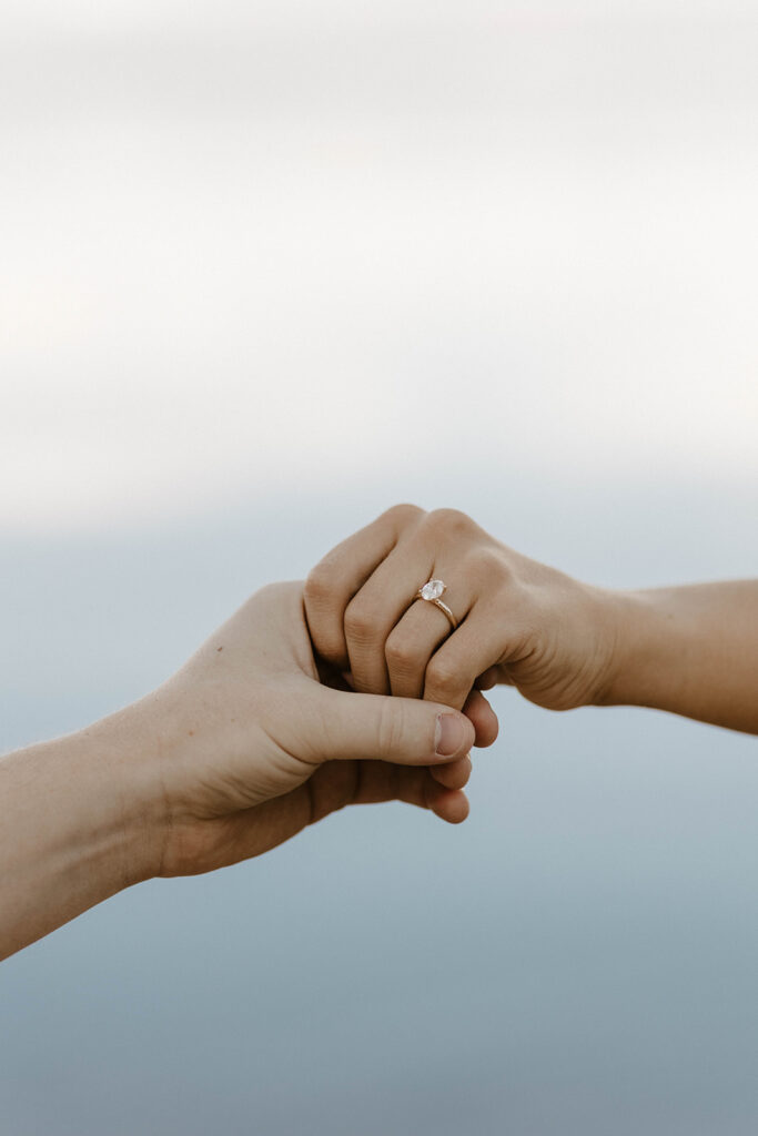 man holding woman's hand wearing a wedding ring