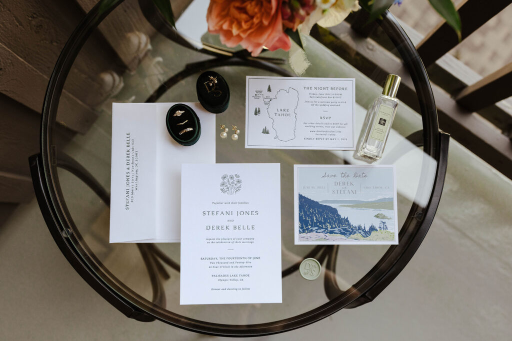 Wedding details in a flat lay on top of a glass table outside at Palisades Tahoe