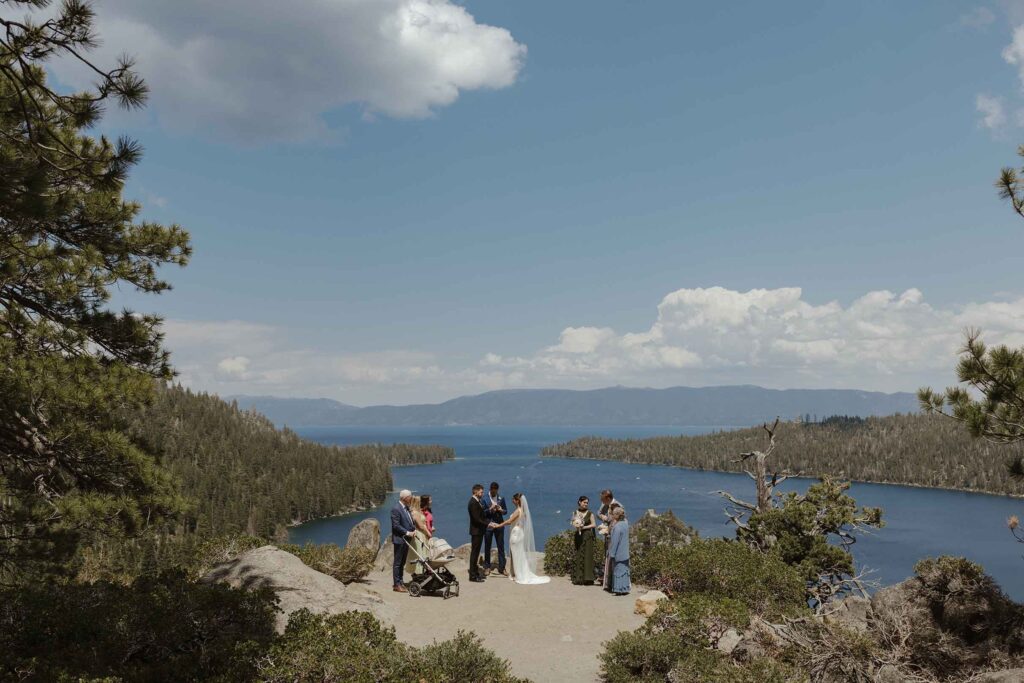 Elopement ceremony at Emerald Bay with Lake Tahoe and mountains covered in pine trees in background