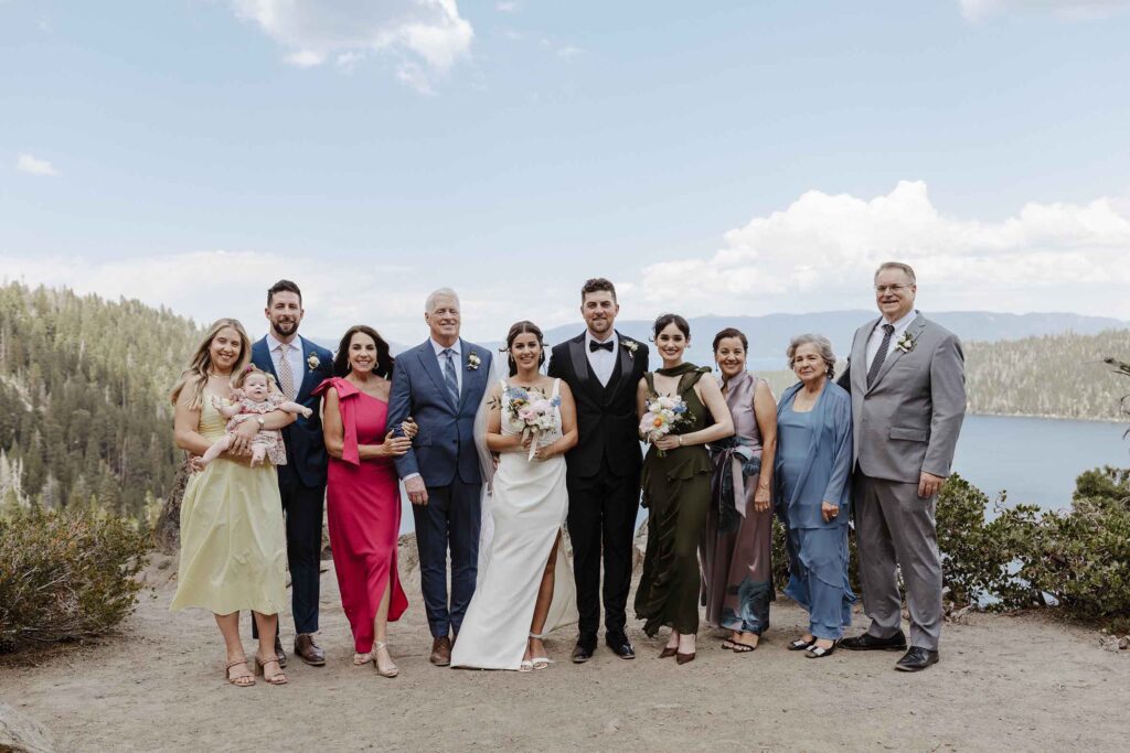 Elopement couple and family standing together and smiling at camera after ceremony at Emerald Bay