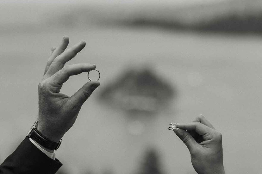 Close up of elopement couple holding up wedding rings together