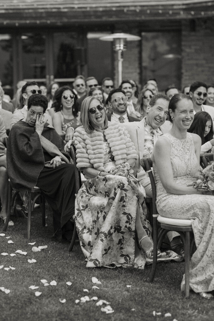 Grooms parents laughing during wedding ceremony at Nakoma Resort
