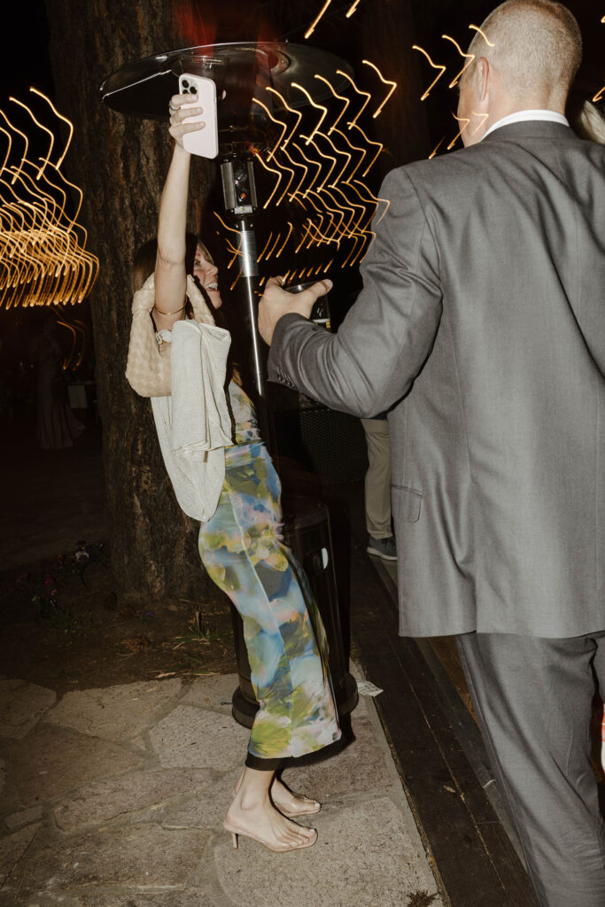Wedding guests dancing during reception while lights blur behind them at Nakoma Resort