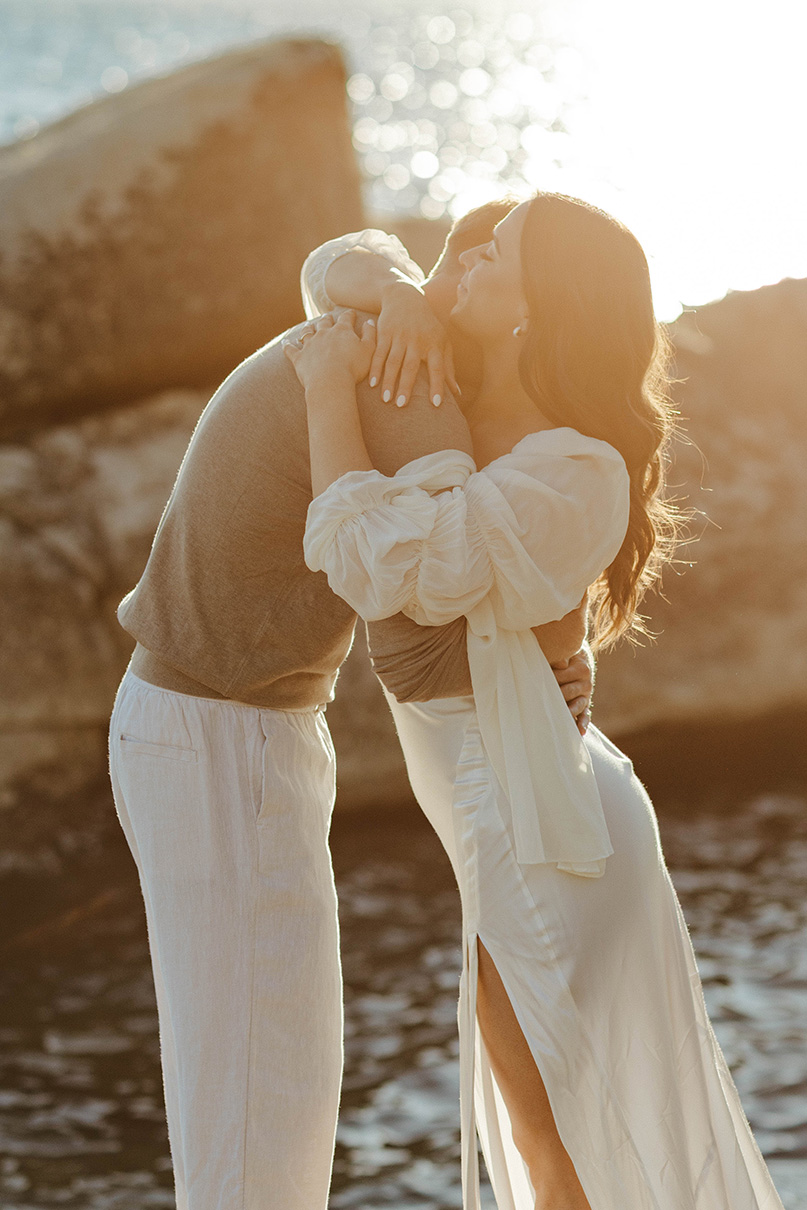 couple hugging at sunset on rocks in north lake tahoe