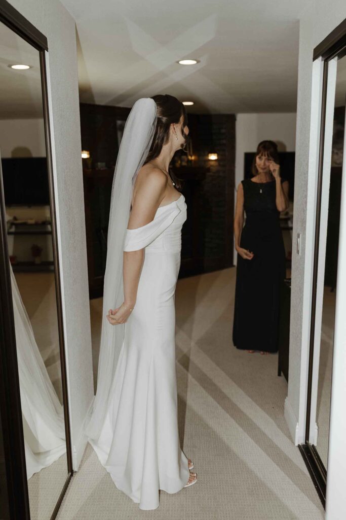 Elopement bride in wedding dress looking at emotional mom in South Lake Tahoe
