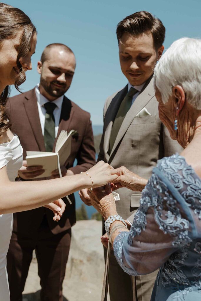 Elopement couple being given wedding rings during ceremony in South Lake Tahoe