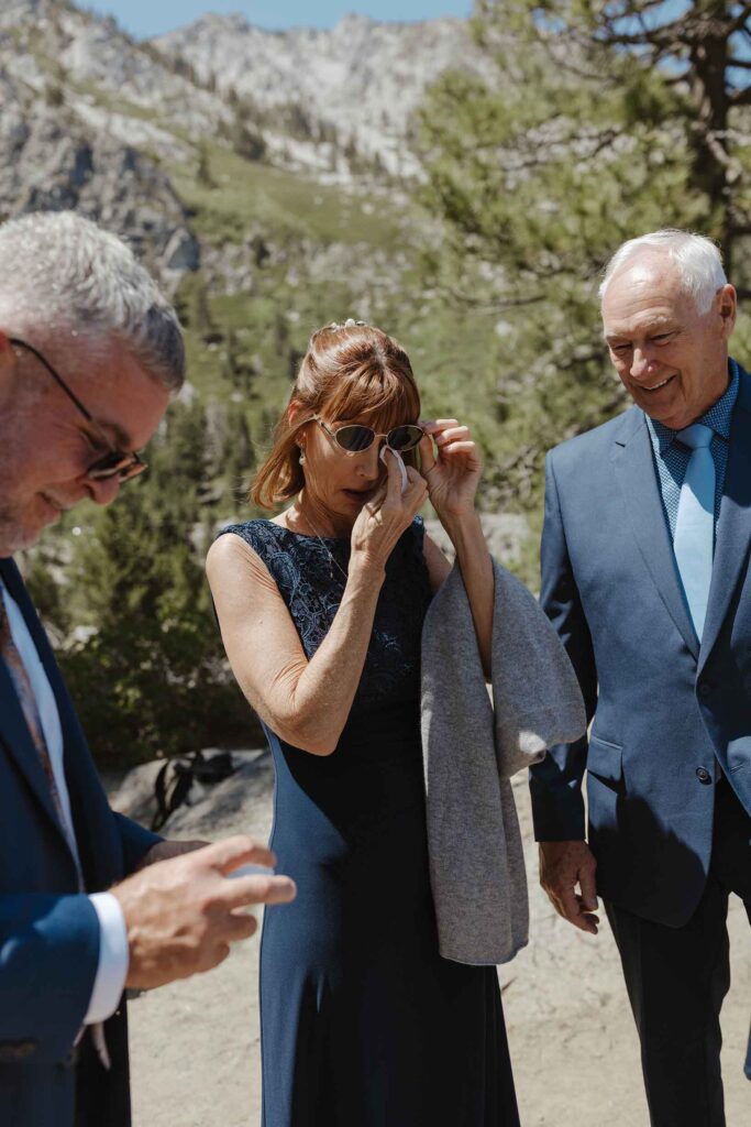 Bride's mom emotional and wiping tears after elopement ceremony in South Lake Tahoe
