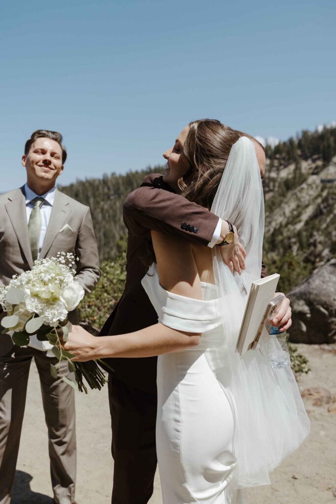 Bride hugging wedding officiant after elopement ceremony in South Lake Tahoe