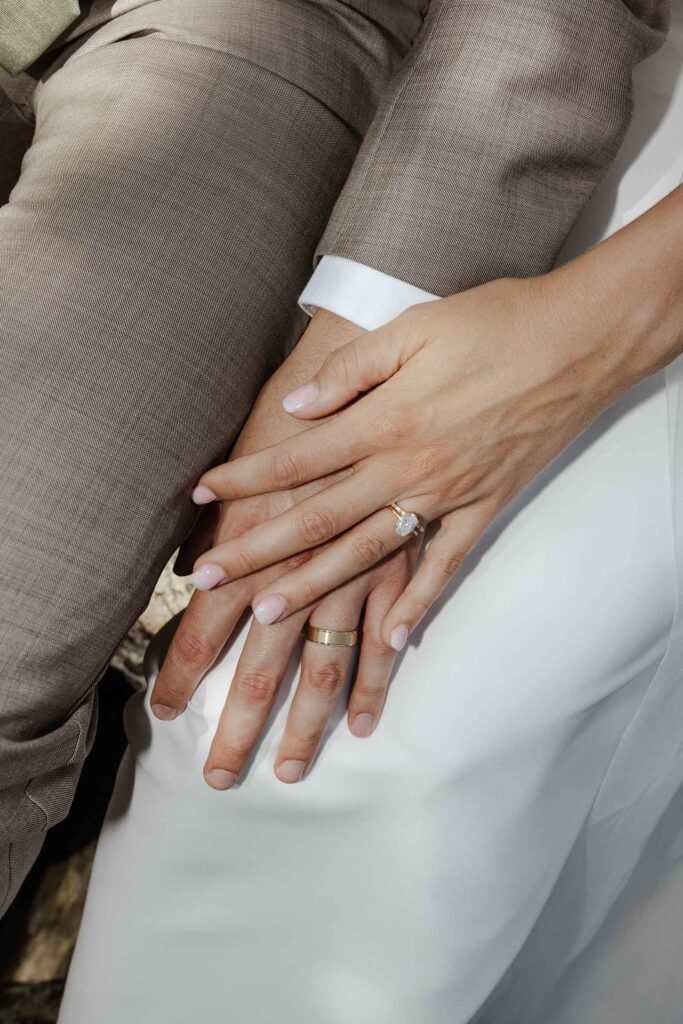 Close up of elopement couple's hands wearing wedding rings in South Lake Tahoe