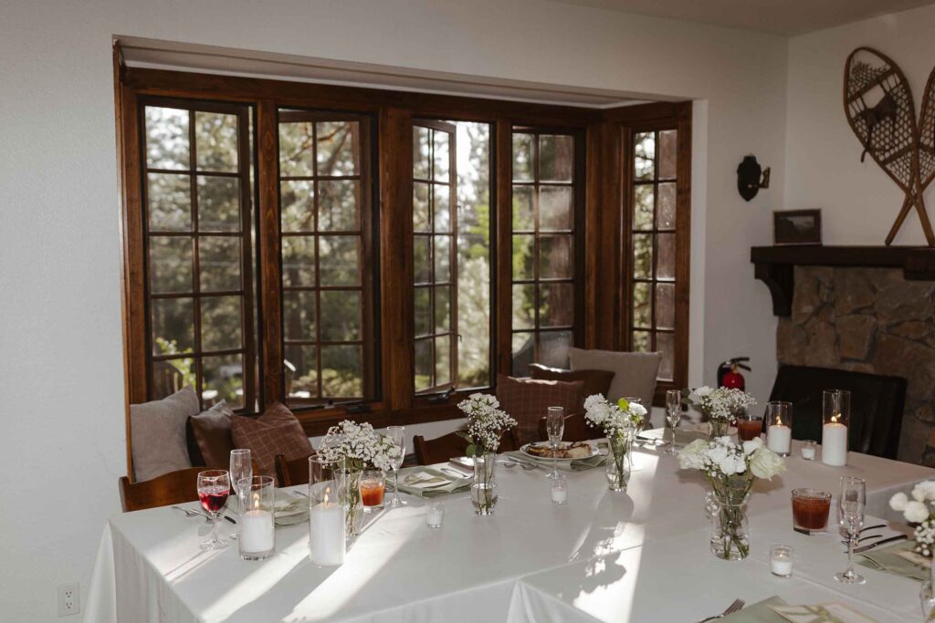 Elopement dinner tables set up in front of wooden windows in South Lake Tahoe