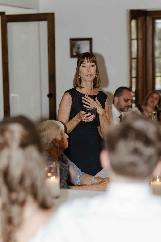 Bride's mom standing and giving speech during elopement reception in South Lake Tahoe