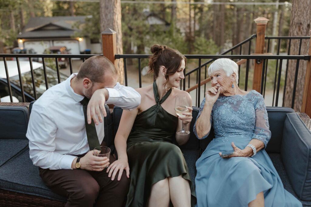 Elopement guest sitting on couch and talking together during reception in South Lake Tahoe