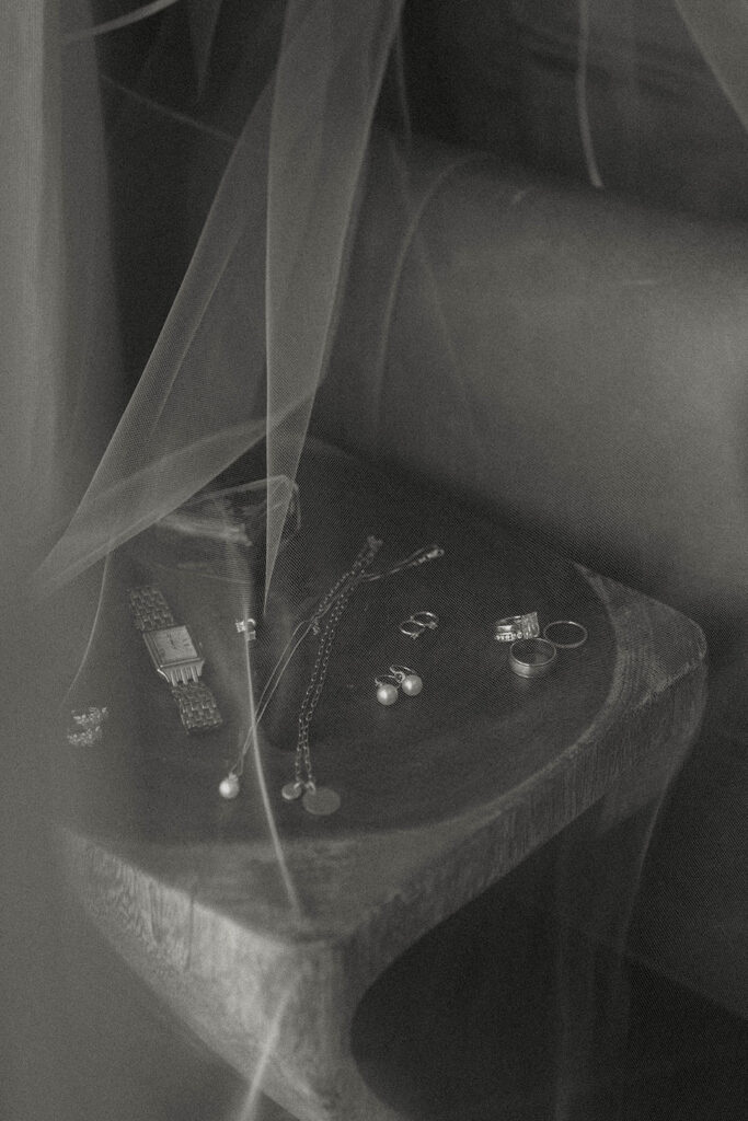 Wedding details with watch and jewelry on table with veil draped over top at the Landing Tahoe Resort