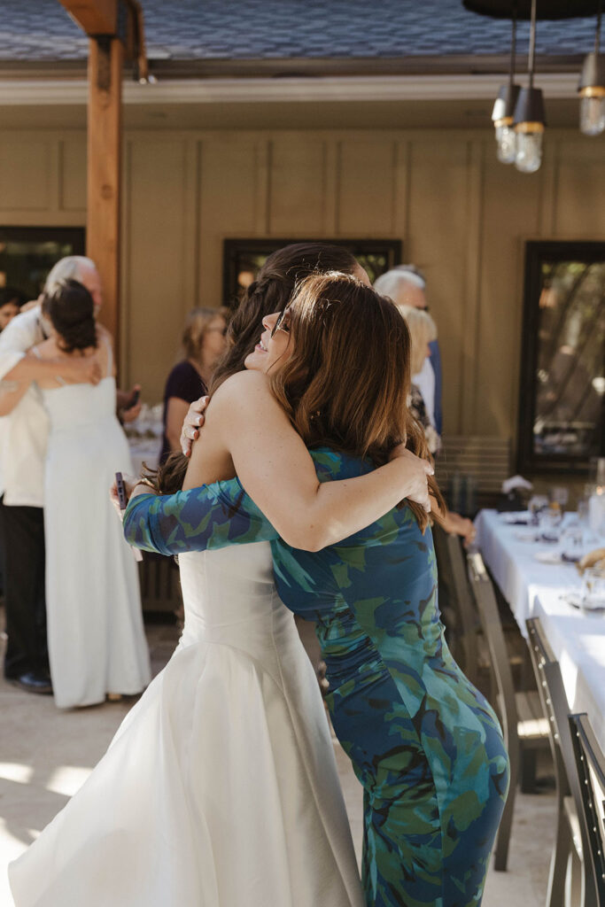 Bride hugging guest at wedding reception at the Landing Tahoe Resort