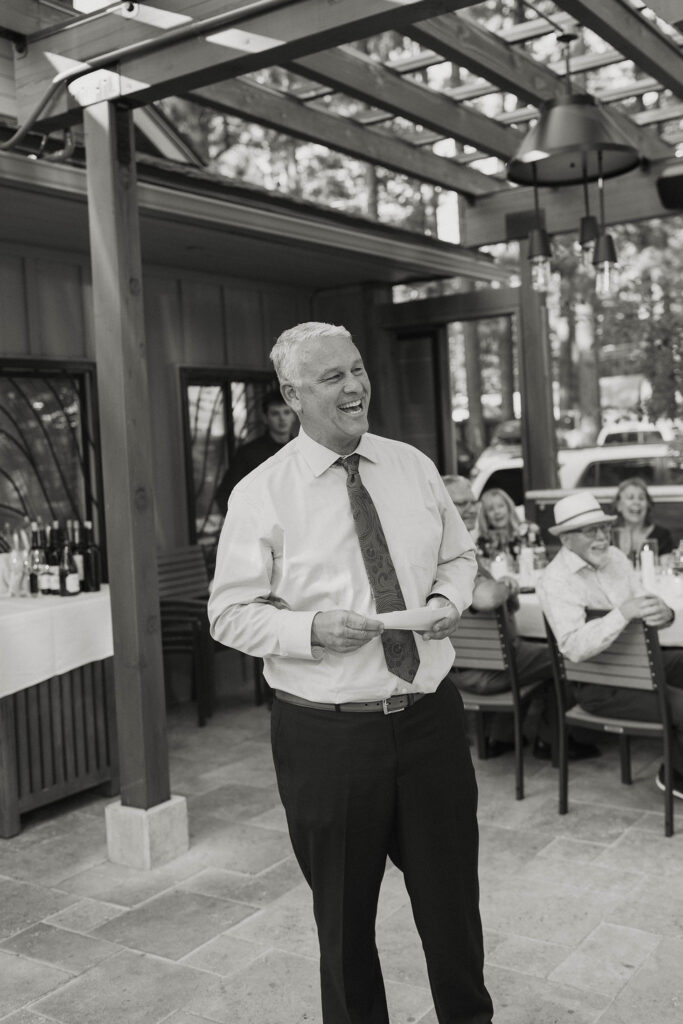 Dad giving speech and laughing during wedding reception at the Landing Tahoe Resort