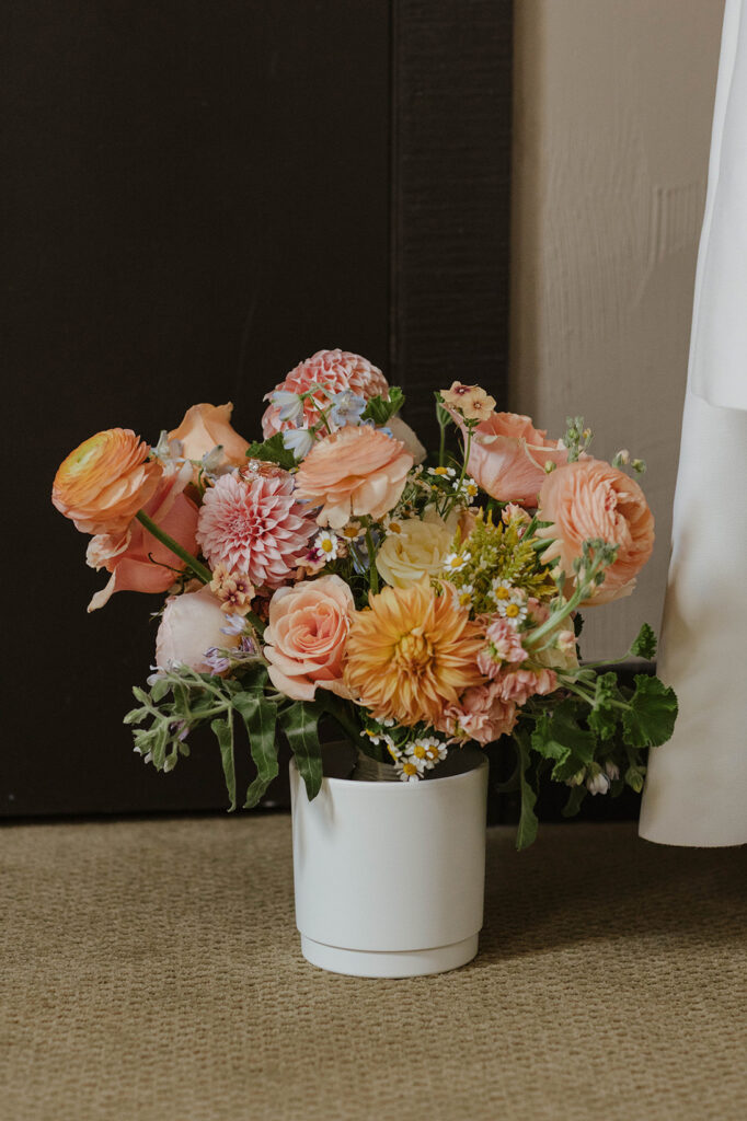 Colorful floral bouquet sitting in white vase inside at PlumpJack Inn