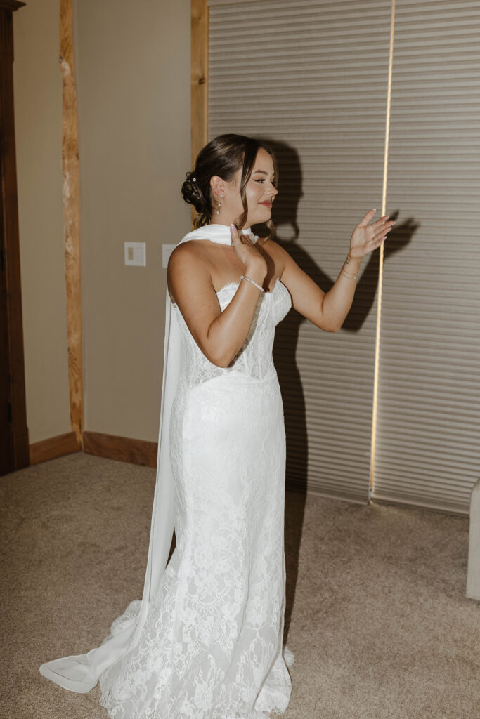 Bride emotional after putting on wedding dress while inside at Austin Ridge Truckee