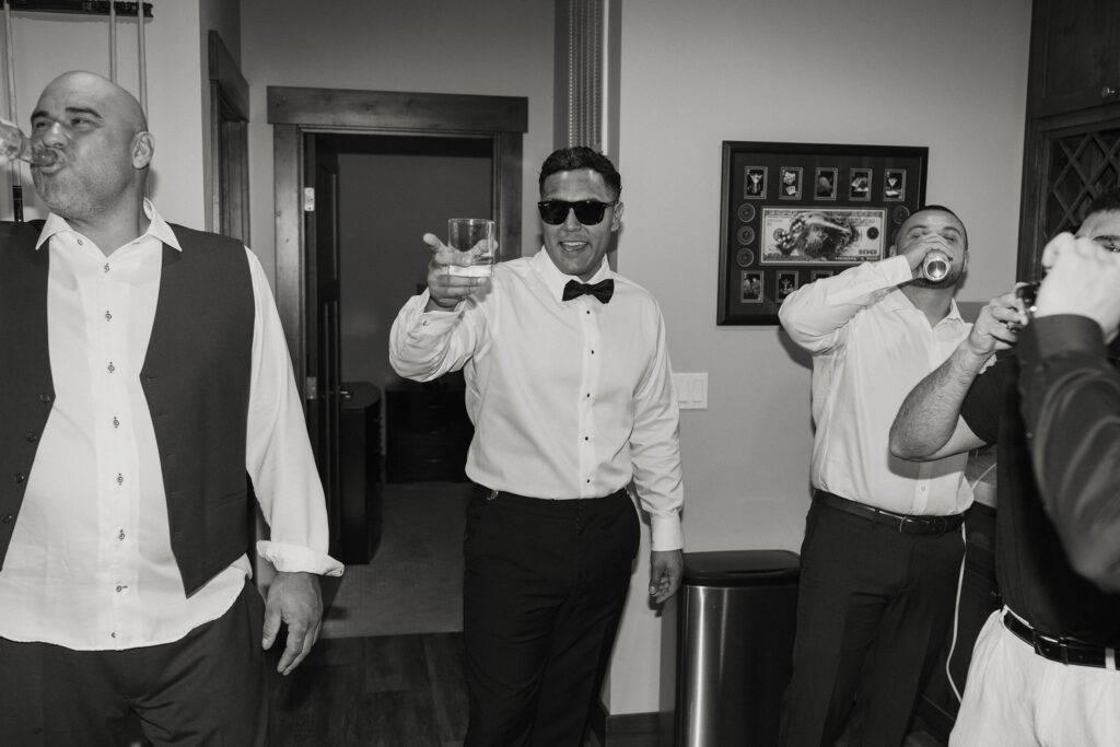 Elopement guests drinking and smiling while inside at Lake Tahoe