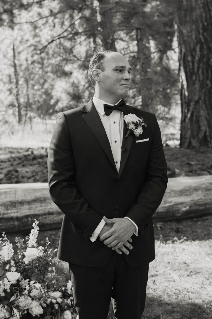Groom emotional watching bride walk down wedding aisle to ceremony at Valhalla Tahoe