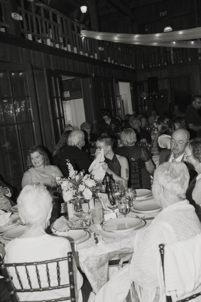 Wedding guest wiping tear with napkin during reception inside at Valhalla Tahoe