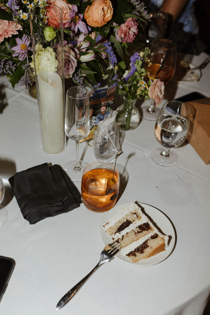 Drinks and dessert sitting on wedding reception table with colorful florals at Edgewood Tahoe