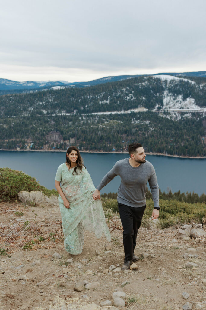 couple holding hands taking maternity photos in lake tahoe