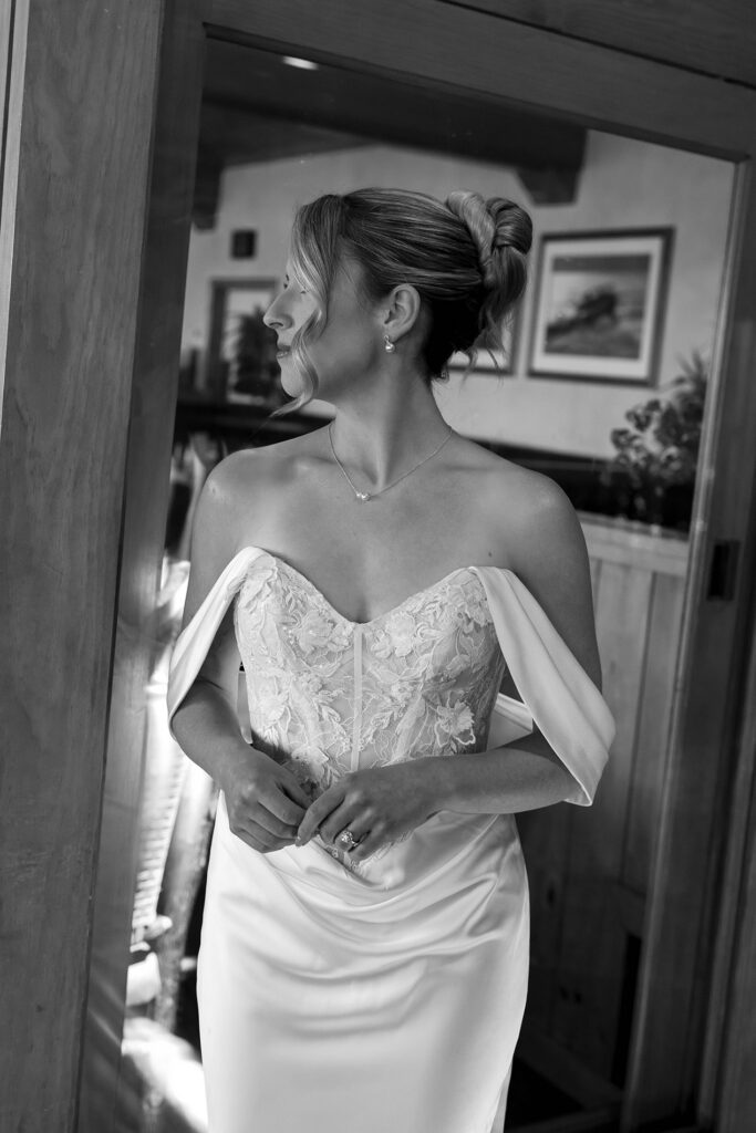 Bride's reflection in mirror while wearing full wedding attire at Garwoods in Lake Tahoe