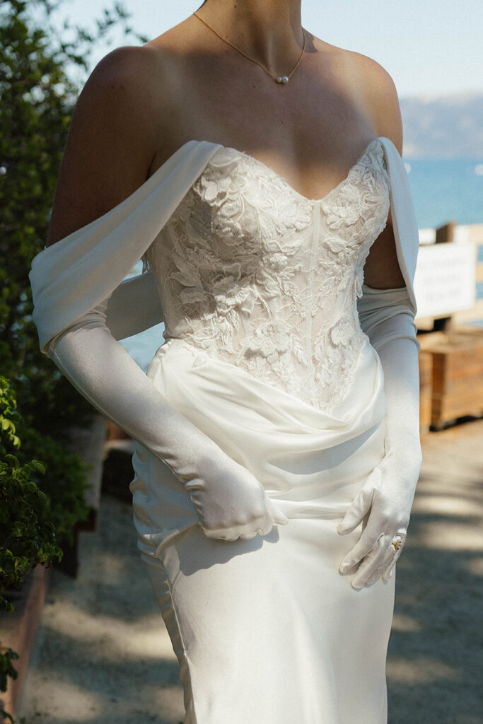 Close up of bride's wedding dress while she stands outside in sunlight at Garwoods in Lake Tahoe