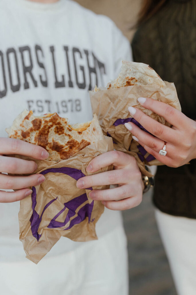 Couple holding Taco Bell in their hands with engagement ring in view at San Fransisco engagement session
