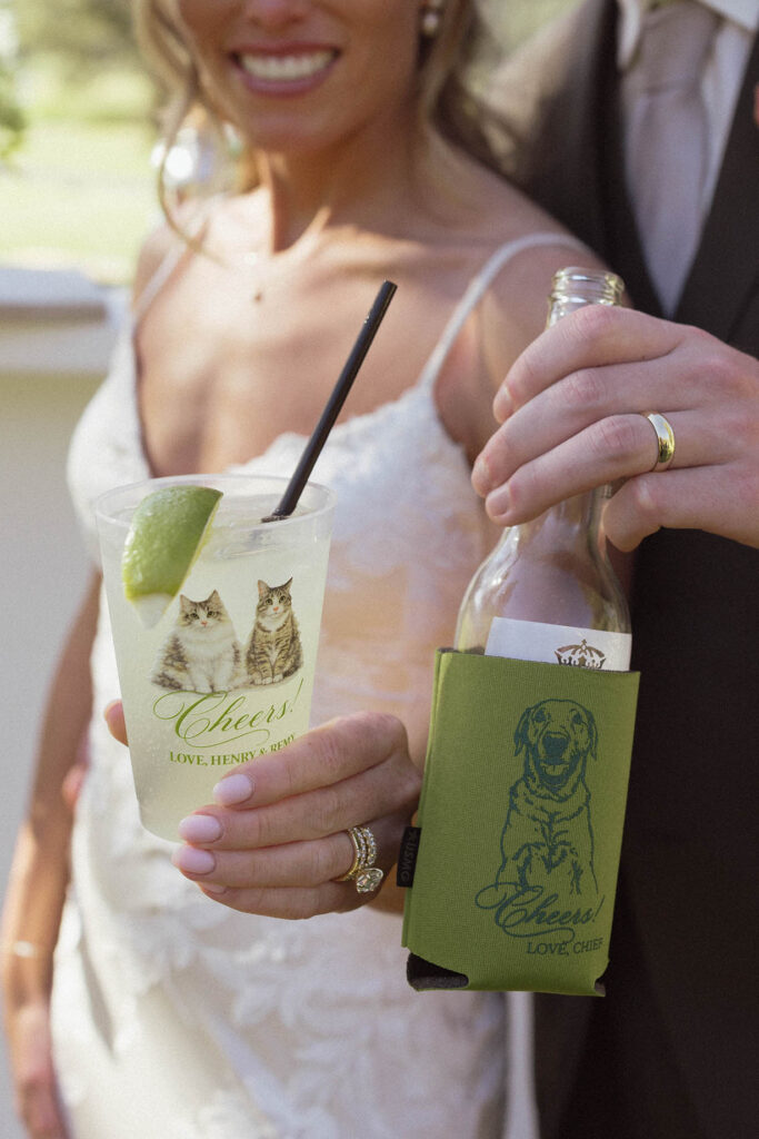 Wedding couple holding drinks up with pictures of their pets on them at Everline Resort in Lake Tahoe