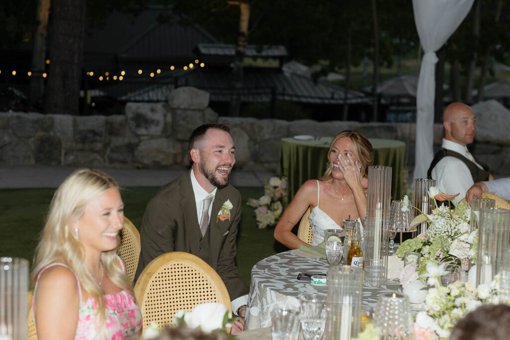 Groom laughing while Bride is wiping tears during reception at Everline Resort in Lake Tahoe