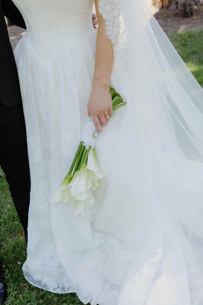 Close up of wedding bride holding white floral bouquet at Kinship Ranch
