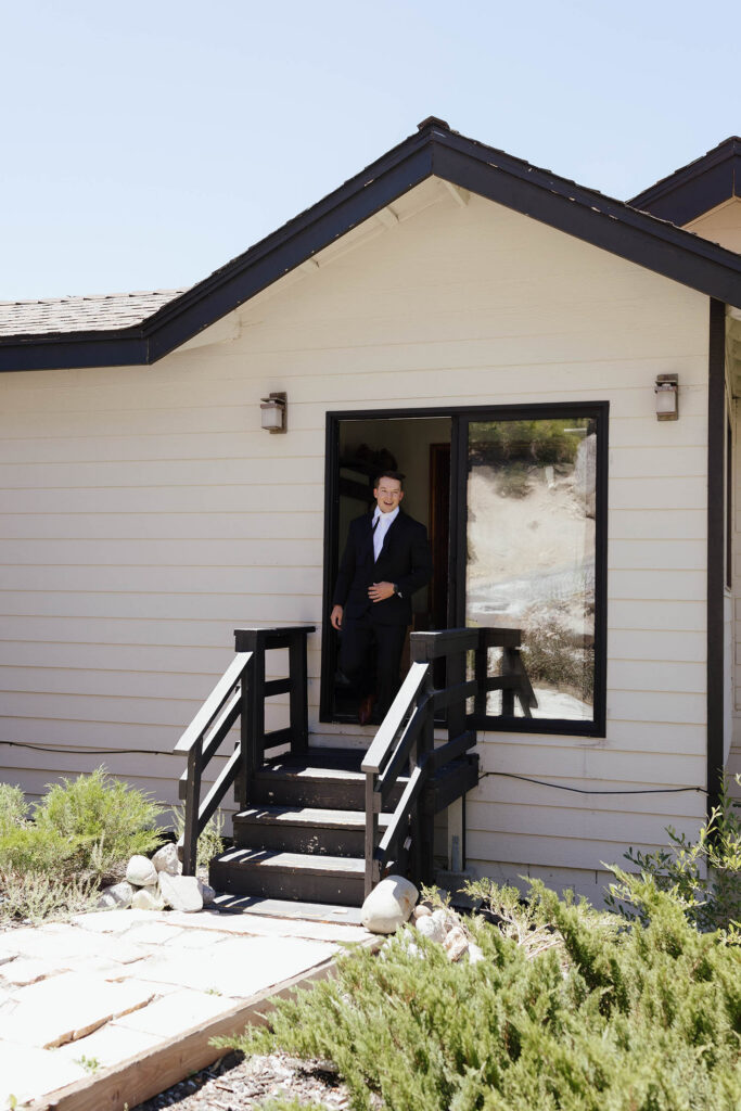 The groom steps outside the South Lake Tahoe Airbnb for the couple’s first look