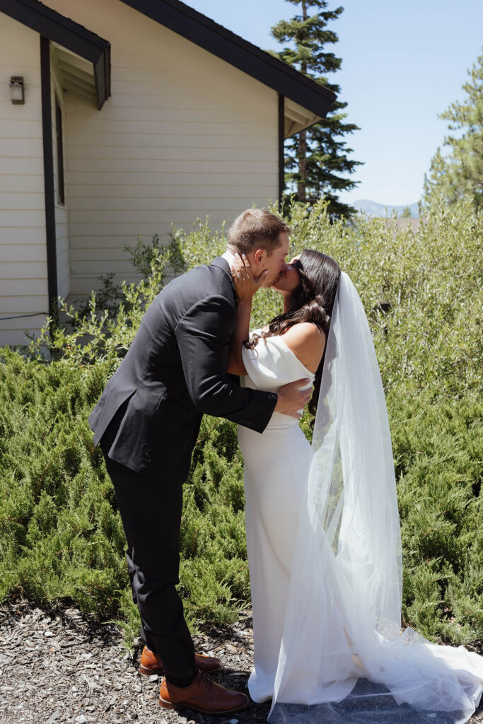 The bride and groom kiss during their first look before their Emerald Bay ceremony