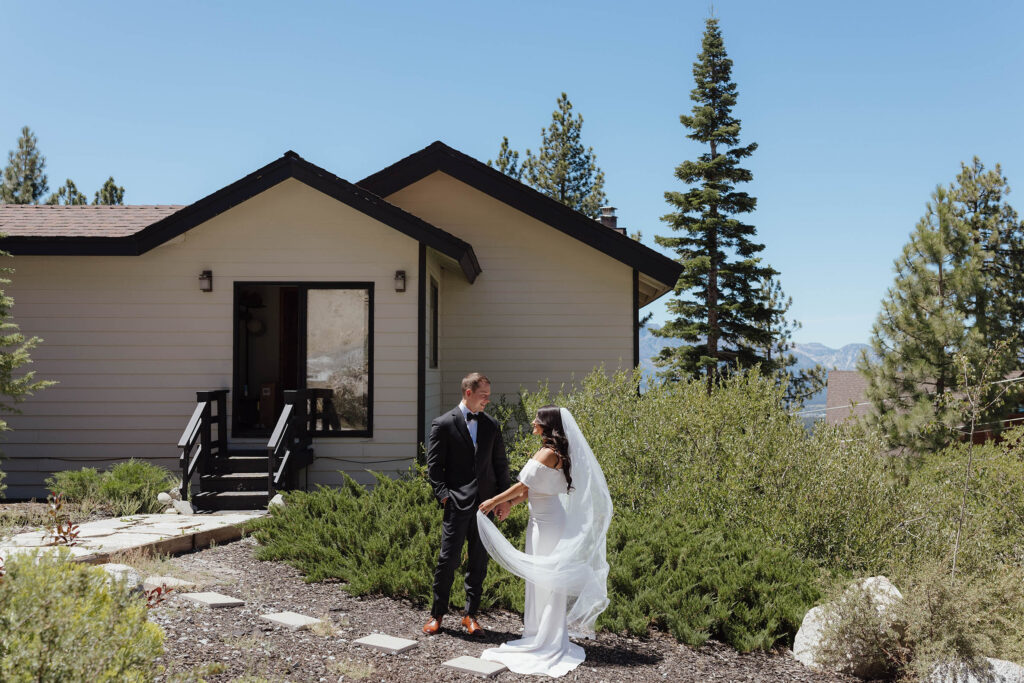 The bride and groom hold hands outside their South Lake Tahoe Airbnb after their first look