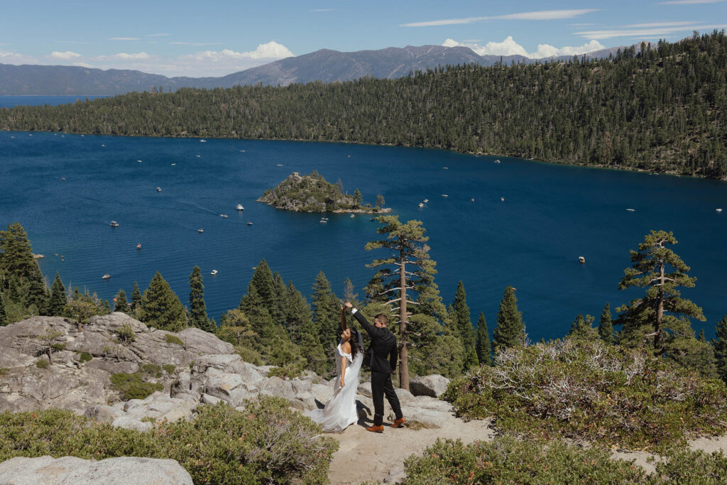 The bride and groom dance above the blue water of Emerald Bay during their Lake Tahoe elopement