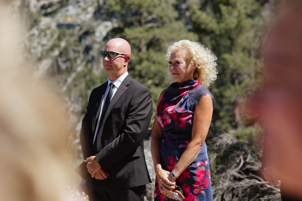 The bride smiles as the groom reads his vows during their Emerald Bay Lake Tahoe elopement ceremony