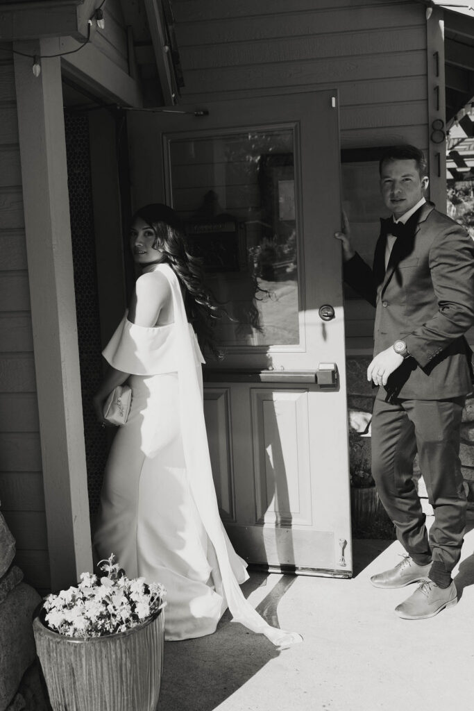 Black-and-white photo of the bride and groom entering Primo’s after their Emerald Bay elopement
