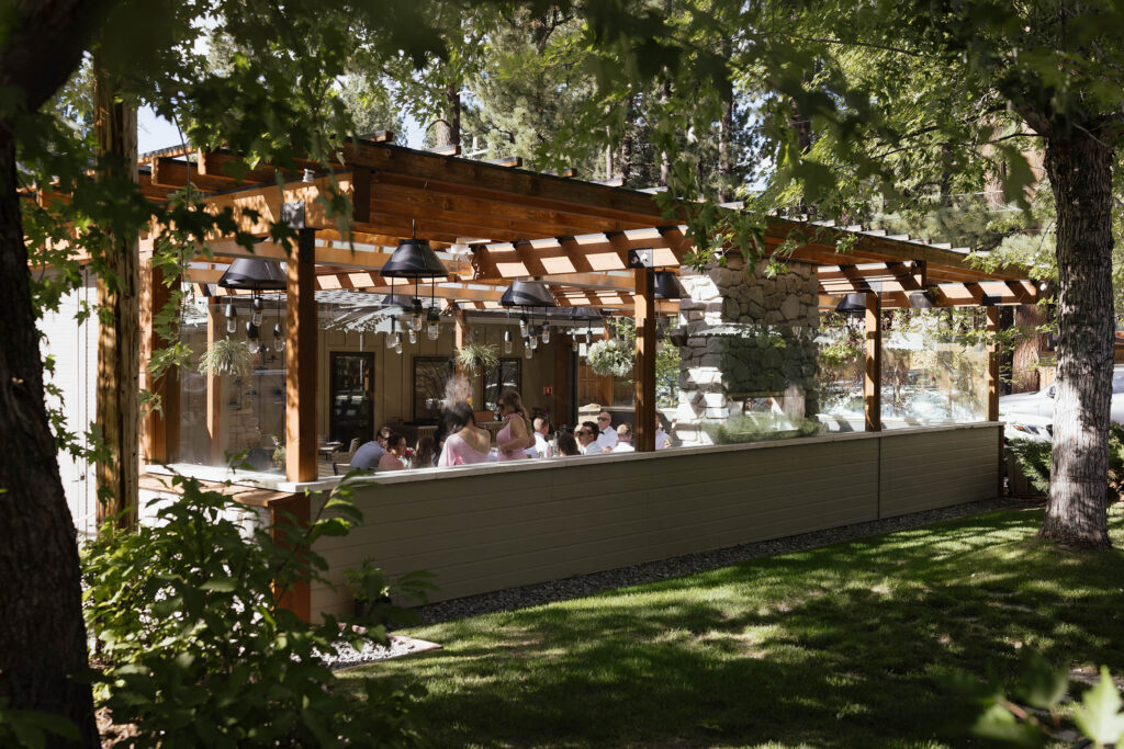 Wedding guests gather beneath the covered patio at Primo’s for the South Lake Tahoe reception