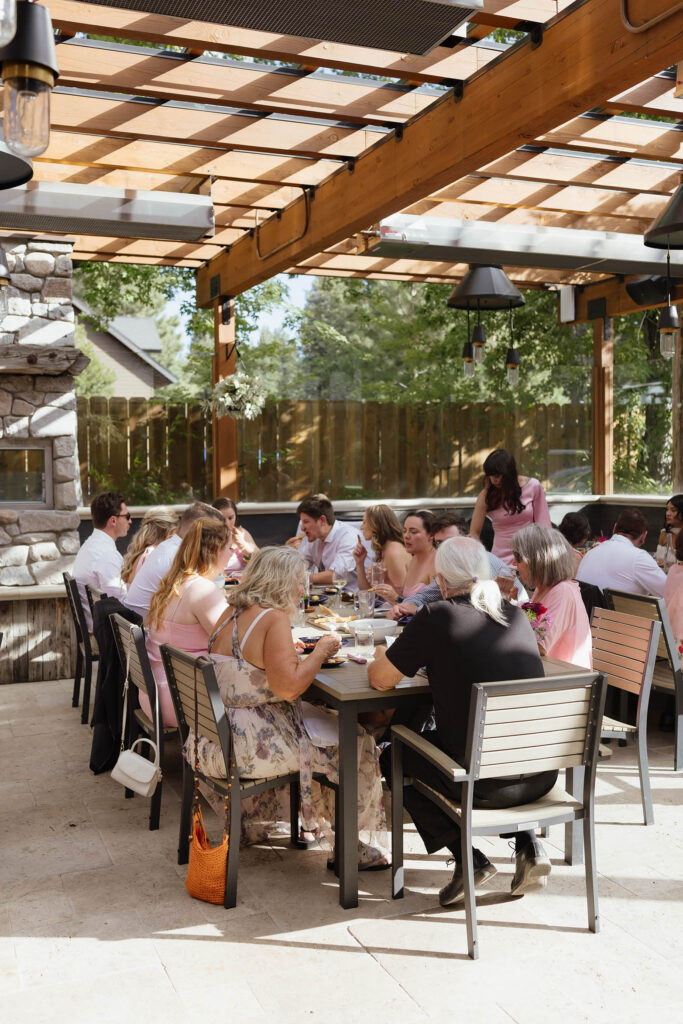 Wedding guests share dinner beneath the covered patio at Primo’s in South Lake Tahoe
