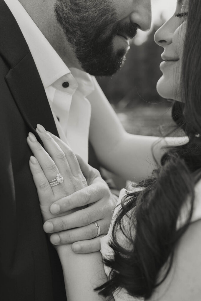 Black and white close up photo of lake tahoe elopement couple holding hands showing rings