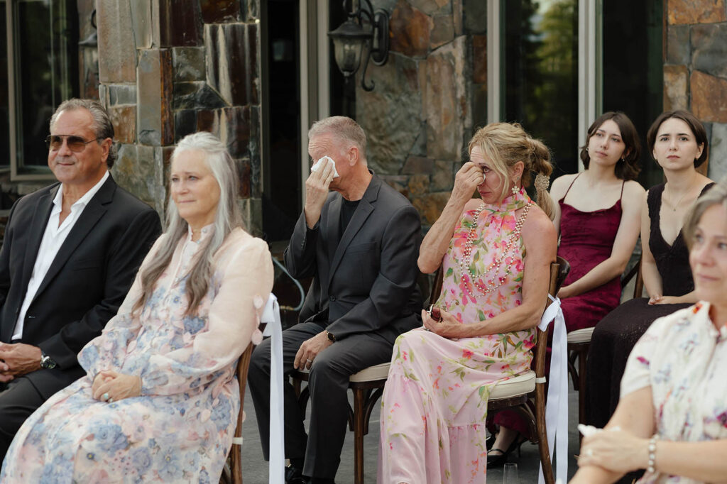 Emotional wedding guests wipe away tears during the ceremony in Lake Tahoe