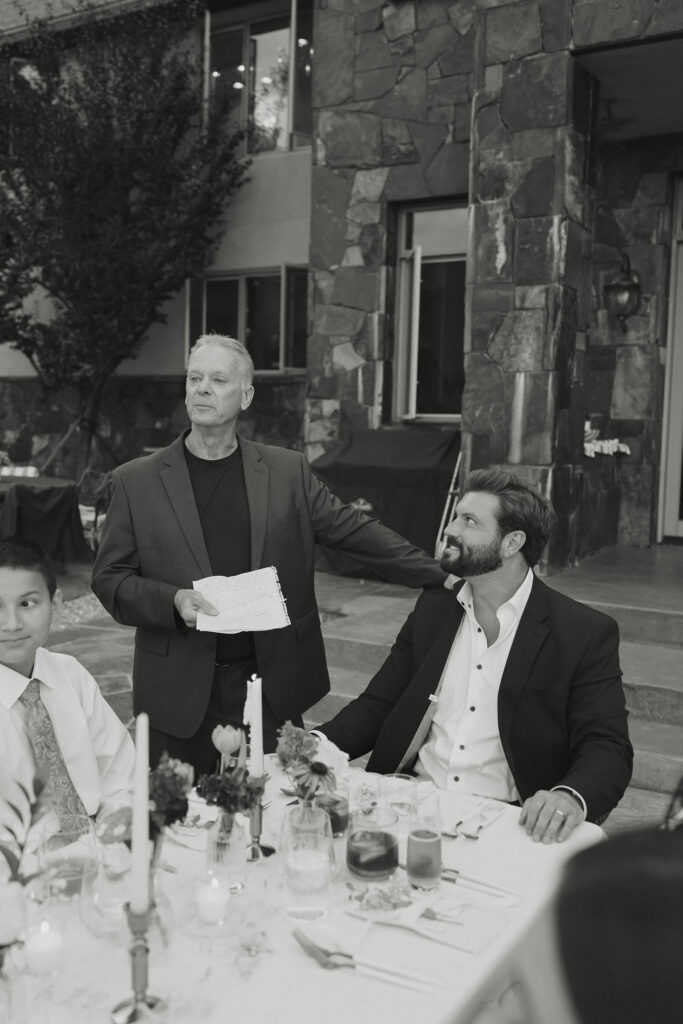 groom's father holding the groom's shoulder giving a speech in Lake Tahoe 