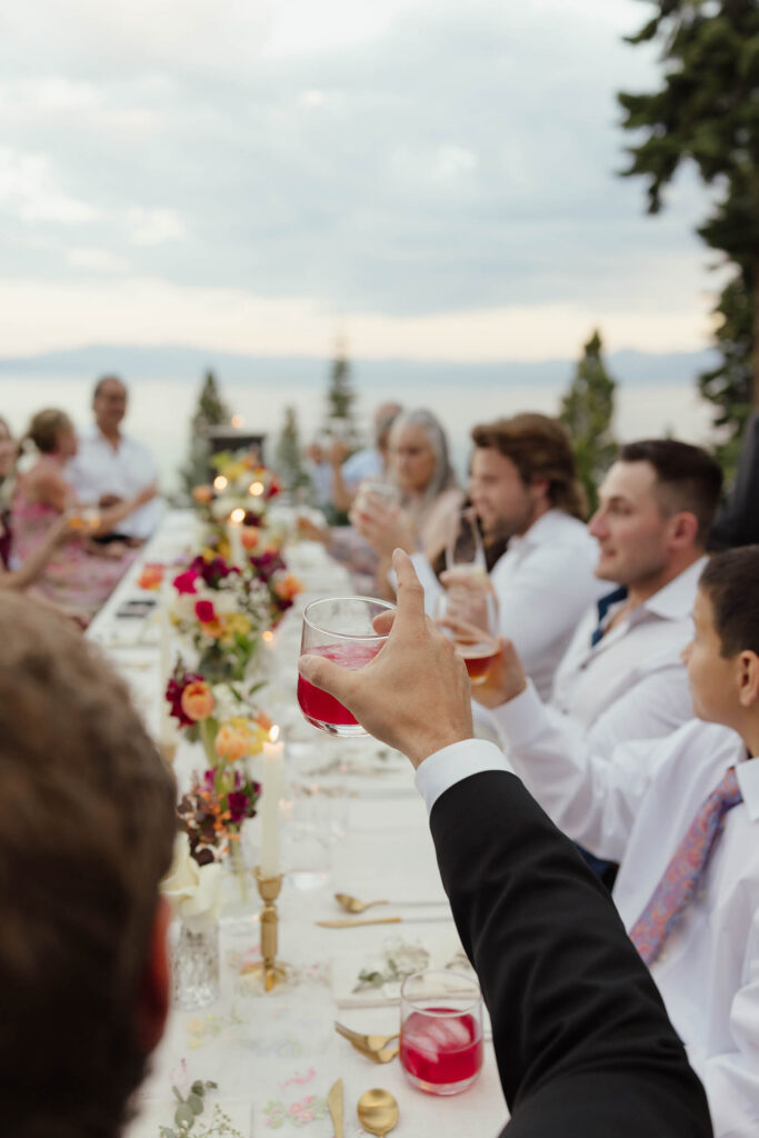 Wedding guests raise their drinks for a toast at Lake Tahoe elopement