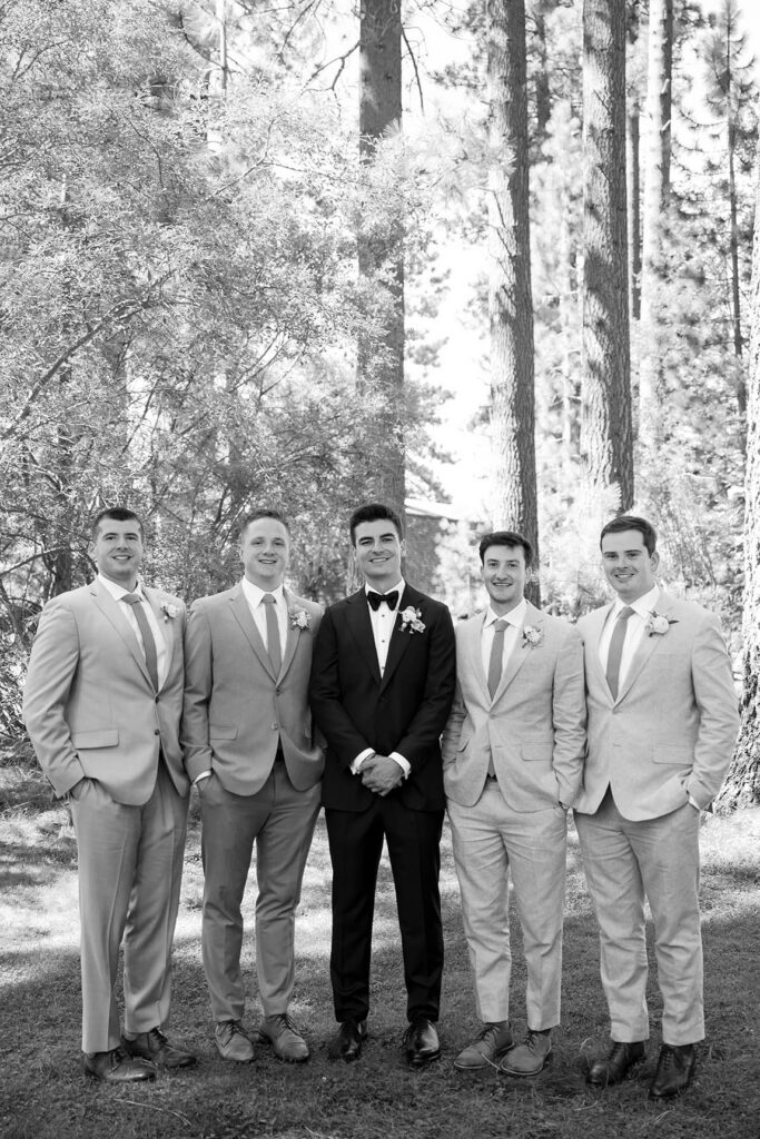 Black-and-white portrait of the groom and groomsmen beneath the Lake Tahoe pine trees