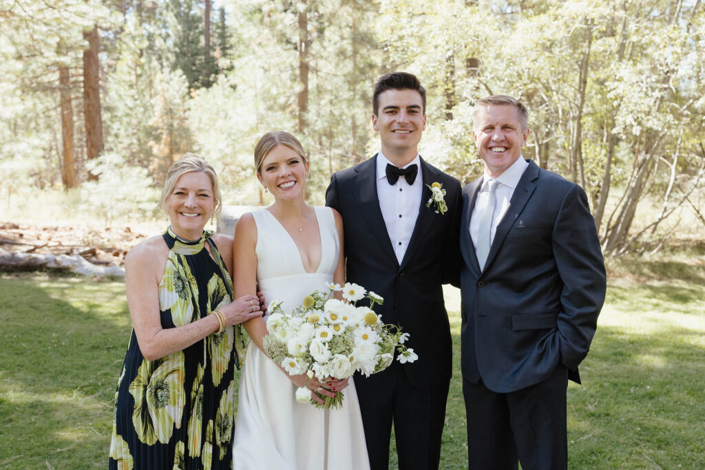 Bride and groom pose with family during their Lake Tahoe wedding