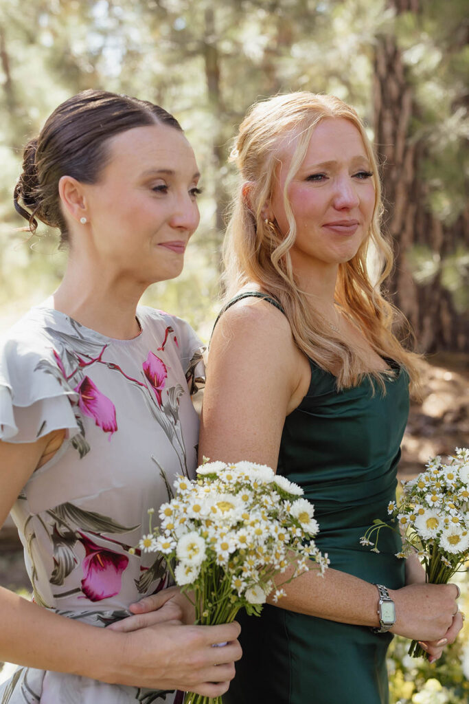 Emotional bridesmaids hold daisy bouquets during the outdoor ceremony at Valhalla Tahoe